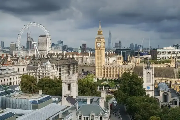 Elevated architectural view of the Palace of Westminster, Big Ben clock tower, and surrounding government offices in London.
