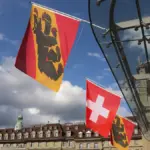 Swiss and Bern flags displayed at Bahnhofplatz in Bern, Switzerland.