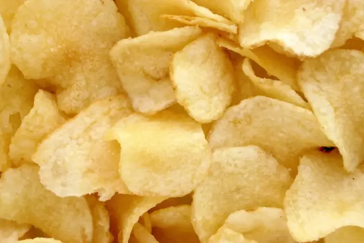 Potato chips representing a commonly consumed packaged snack food.