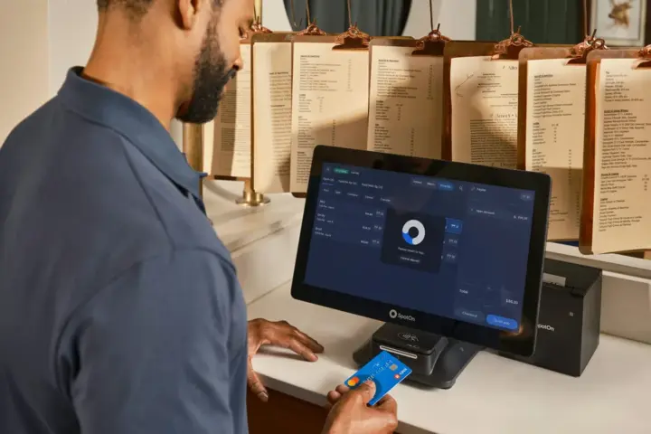 Customer paying by credit card at a payment terminal