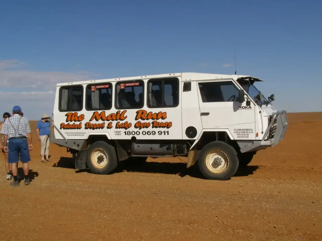 A 4WD mail truck driving through the Australian outback, representing the off-road culture central to Australian Off Road's business.