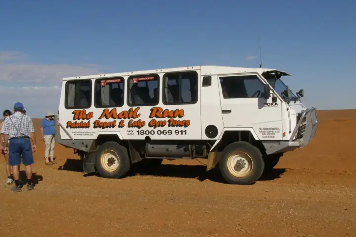 A 4WD mail truck driving through the Australian outback, representing the off-road culture central to Australian Off Road's business.