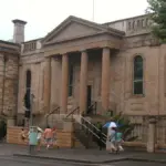 Exterior view of the historic sandstone Big School building and grounds of Sydney Grammar School in central Sydney.