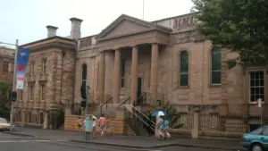 Exterior view of the historic sandstone Big School building and grounds of Sydney Grammar School in central Sydney.