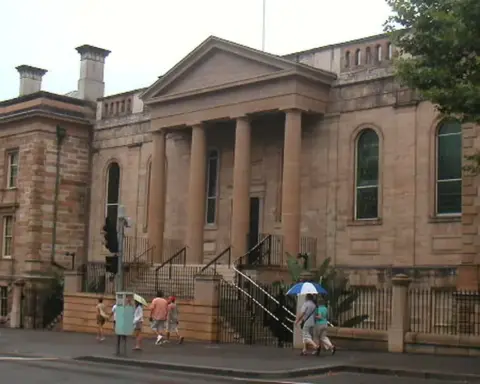 Exterior view of the historic sandstone Big School building and grounds of Sydney Grammar School in central Sydney.