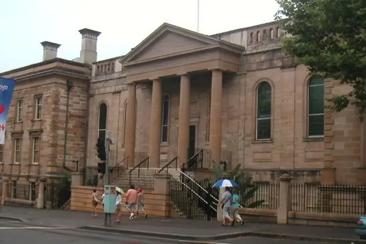 Exterior view of the historic sandstone Big School building and grounds of Sydney Grammar School in central Sydney.