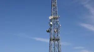 A telecommunications tower with multiple antennas set against the sky.
