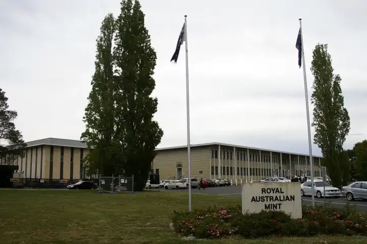 Clean architectural exterior photograph of the Royal Australian Mint building entrance and grounds in Deakin, Canberra.