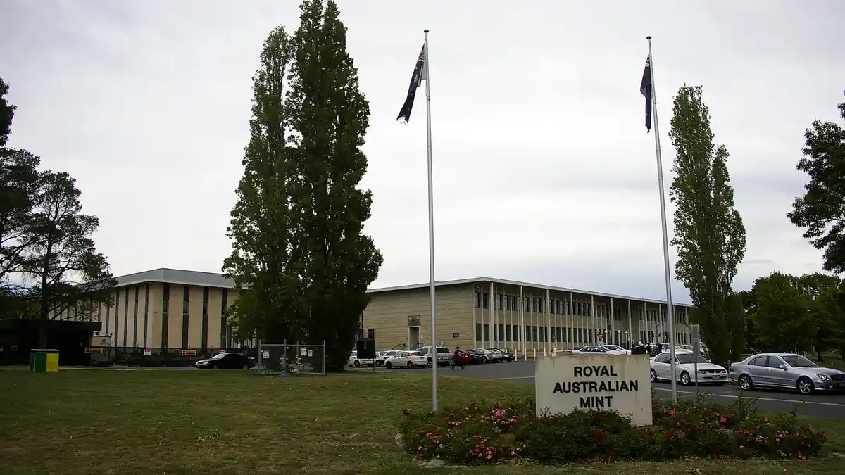 Clean architectural exterior photograph of the Royal Australian Mint building entrance and grounds in Deakin, Canberra.