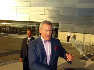 Close-up color photograph of actor Bruce Campbell speaking candidly into a microphone during a panel discussion.