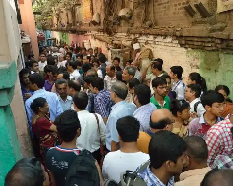 Candidates and guardians gathered outside the entrance gates of a designated central board examination center.