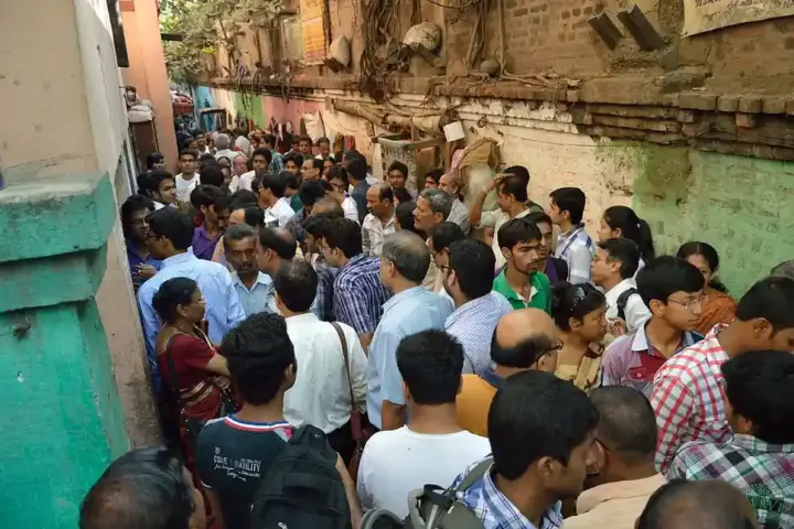 Candidates and guardians gathered outside the entrance gates of a designated central board examination center.