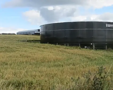 Farm slurry tank structure in a rural agricultural setting