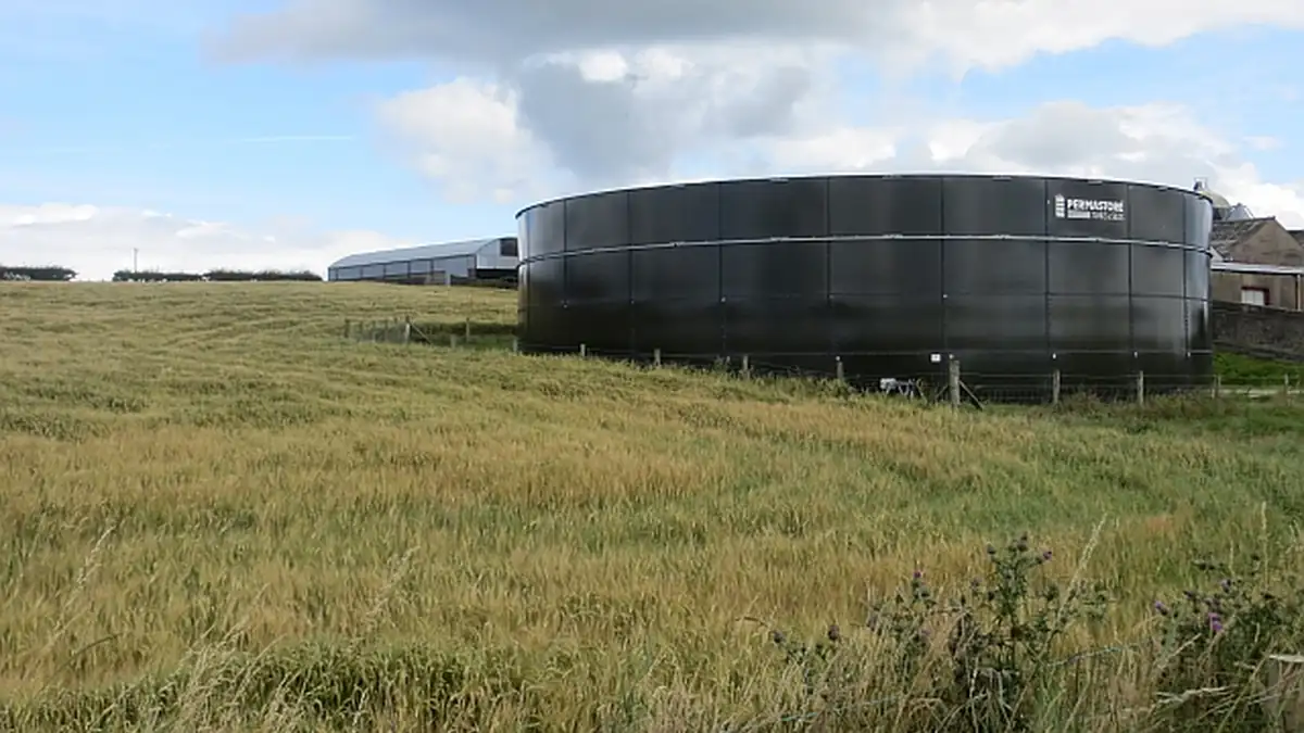 Farm slurry tank structure in a rural agricultural setting