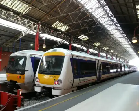 Silver and yellow Chiltern Railways passenger train at a UK station platform