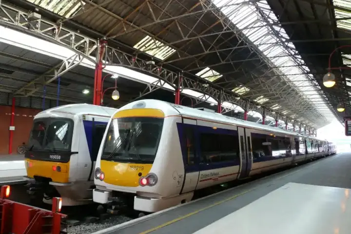 Silver and yellow Chiltern Railways passenger train at a UK station platform
