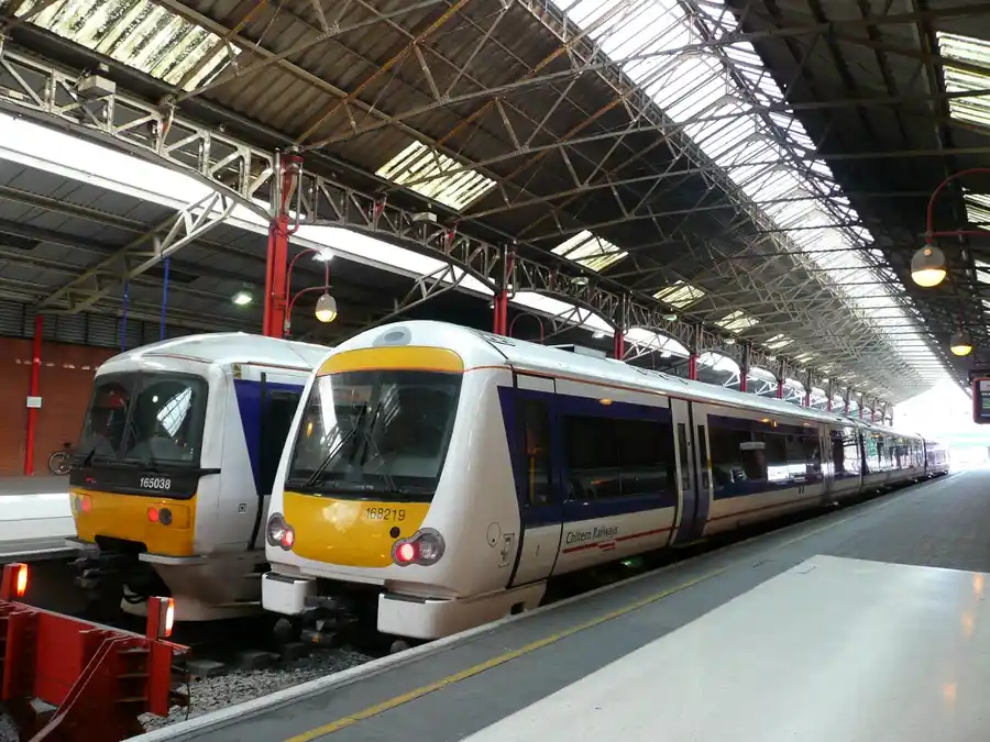 Silver and yellow Chiltern Railways passenger train at a UK station platform