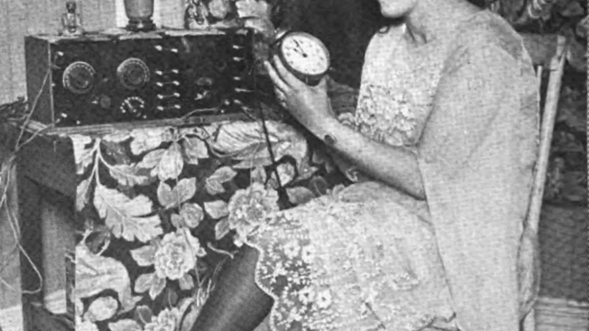 Woman adjusting a clock after the end of daylight saving time.