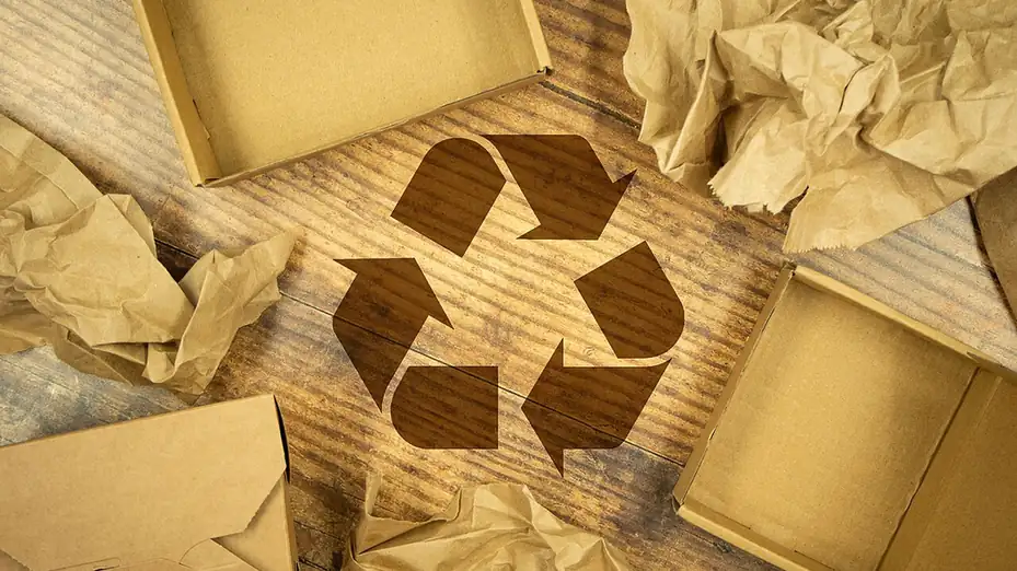 Recycling symbol surrounded by cardboard boxes and paper packaging