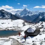 Snow-covered Himalayan mountains reflected in a mountain lake at Chola Valley Nepal