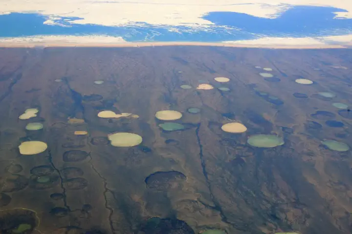 Thaw ponds forming on permafrost in Hudson Bay Canada as Arctic temperatures rise