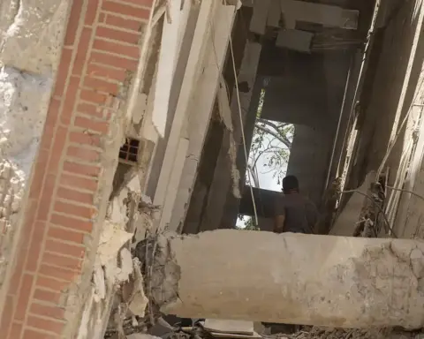 Residents walking through earthquake rubble in La Guaira, Venezuela
