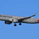 An American Airlines commercial passenger aircraft descending on final approach toward an airport runway