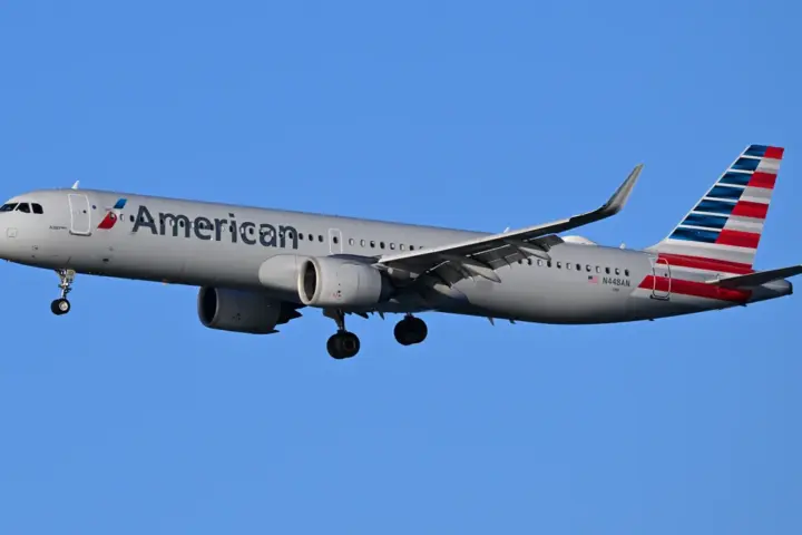 An American Airlines commercial passenger aircraft descending on final approach toward an airport runway