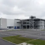 German industrial manufacturing plant exterior with production buildings and steel structures