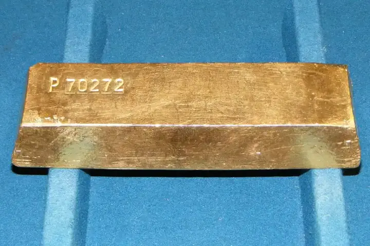 Solid 400-ounce investment-grade gold bullion bar showing reflective metallic finish and purity markings.