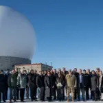 U.S. Space Force Gen. Chance Saltzman and guests stand before a radar dome at Pituffik Space Base, Greenland, April 5, 2023.