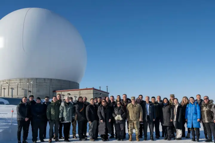 U.S. Space Force Gen. Chance Saltzman and guests stand before a radar dome at Pituffik Space Base, Greenland, April 5, 2023.