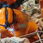NDRF rescuers search through rubble after the Satya Niketan building collapse in Delhi.