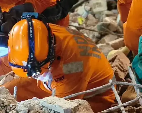 NDRF rescuers search through rubble after the Satya Niketan building collapse in Delhi.