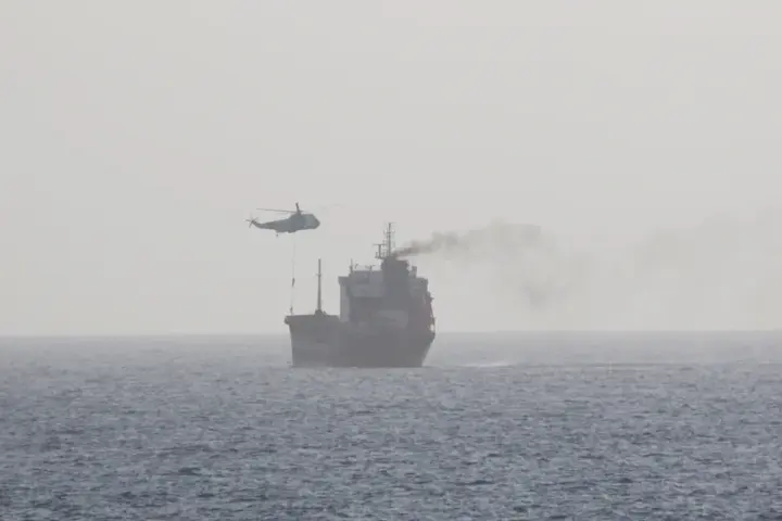 High-angle aerial photograph of a loaded commercial motor tanker vessel transiting open international waters in the Gulf region.