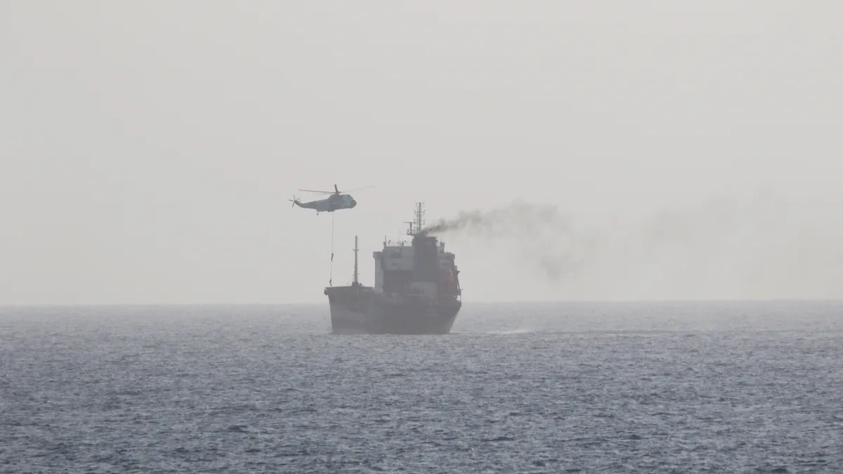 High-angle aerial photograph of a loaded commercial motor tanker vessel transiting open international waters in the Gulf region.