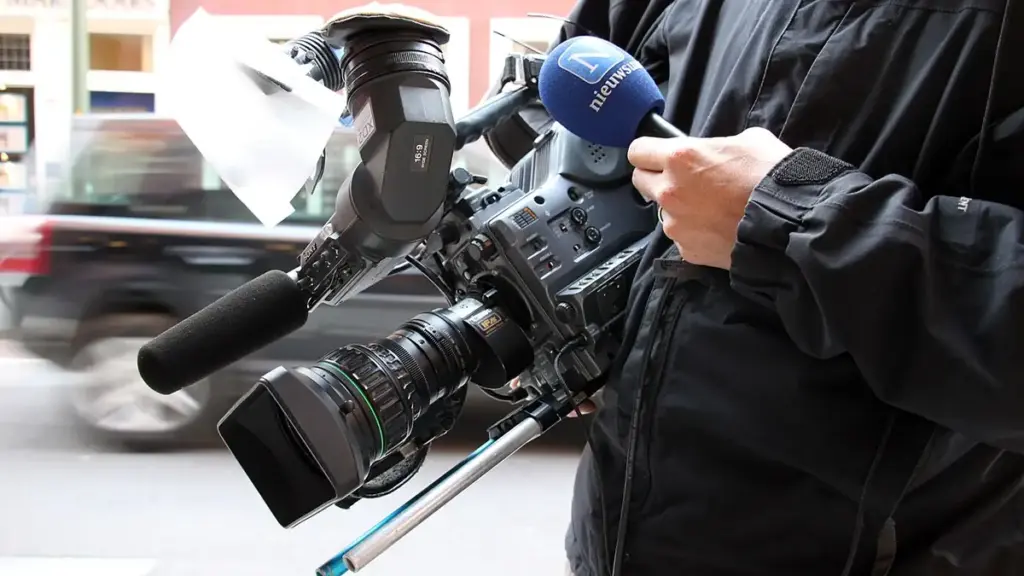 A professional broadcast television camera positioned inside a studio.