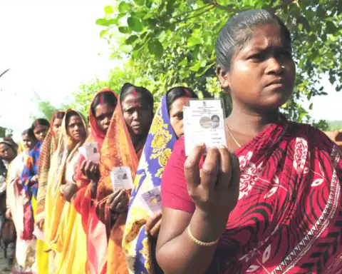 Voters standing in a queue at a polling station in India
