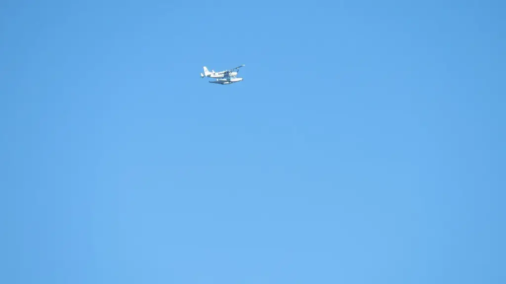 Cessna 208 Caravan aircraft flying over coastal water during approach