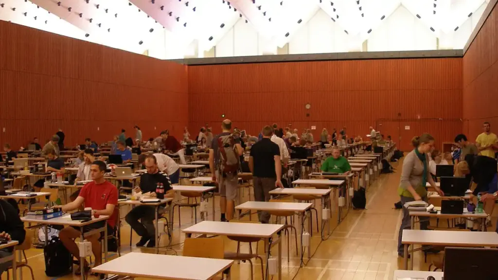 Rows of students seated at desks in an examination hall