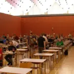 Rows of students seated at desks in an examination hall