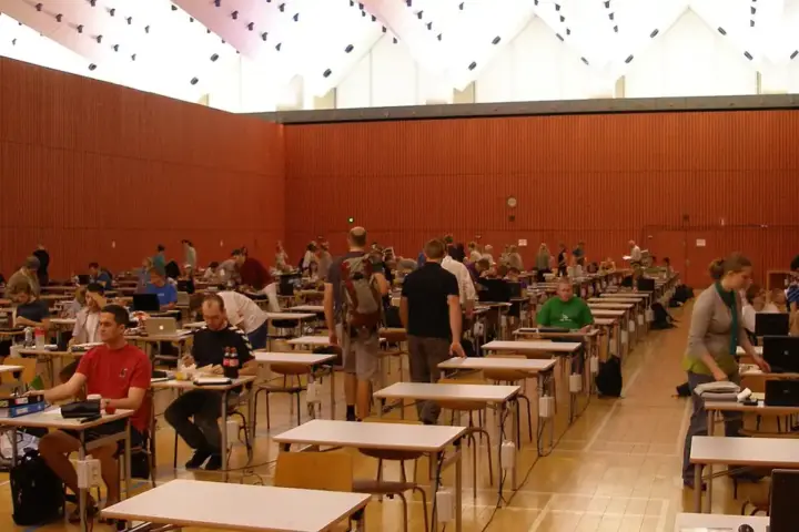 Rows of students seated at desks in an examination hall