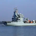 Naval warship sailing on open sea under daylight