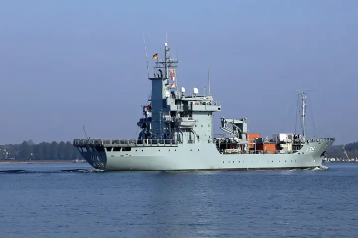 Naval warship sailing on open sea under daylight