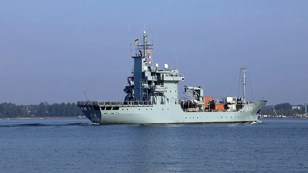 Naval warship sailing on open sea under daylight