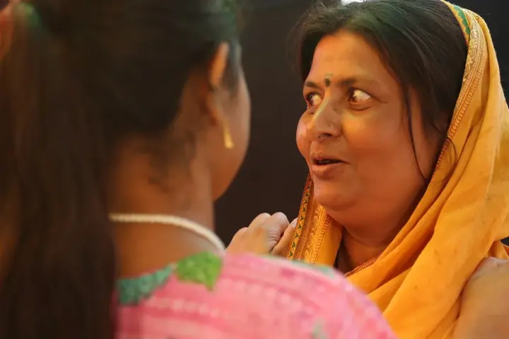 Indian women speaking in a community setting
