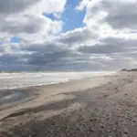 Ocean surf breaking onto a sandy Atlantic coastal beach in the Outer Banks