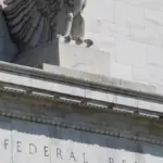 Eagle sculpture and carved pediment at the Federal Reserve Building entrance in Washington D.C.