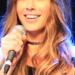 British actress Kate Beckinsale speaking during a public appearance.