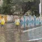 Heavy rain falling on an urban road, used to illustrate Kerala rain and health precautions